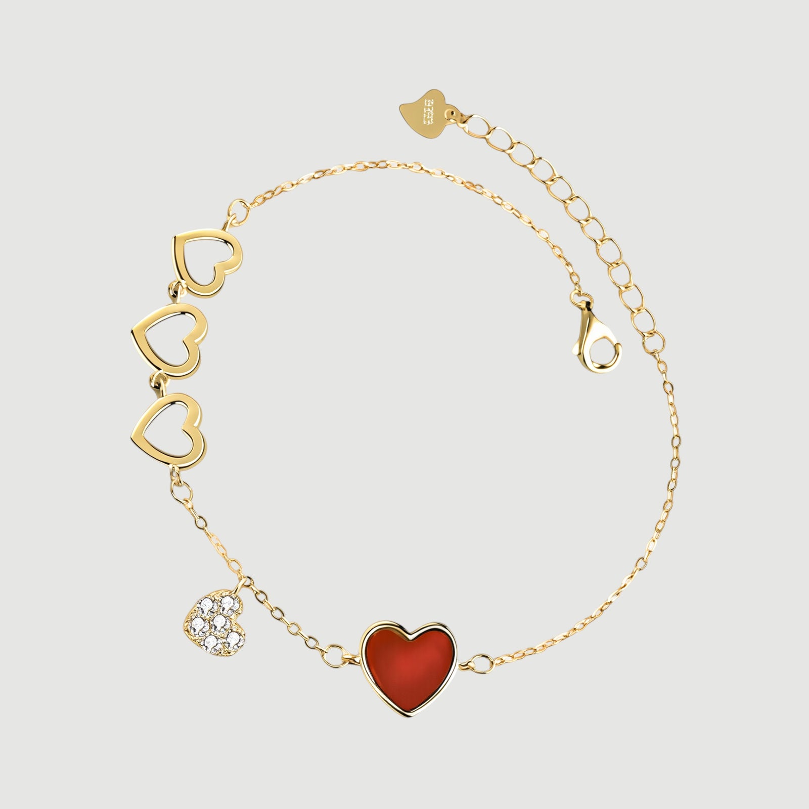 Amara Jewels gold-finished sterling silver bracelet with red enamel heart, cubic zirconia charm, and open hearts.