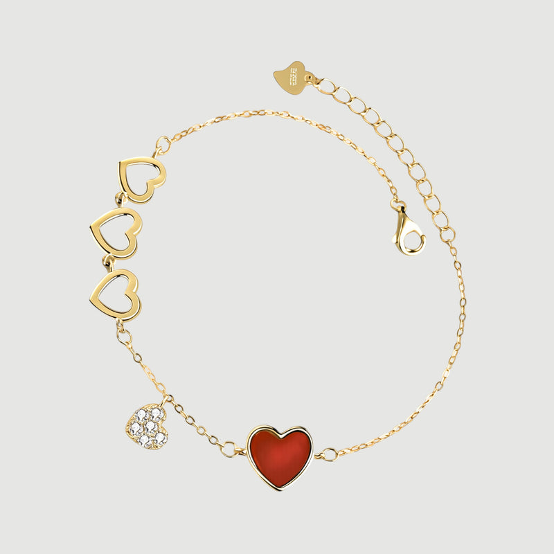 Amara Jewels gold-finished sterling silver bracelet with red enamel heart, cubic zirconia charm, and open hearts.
