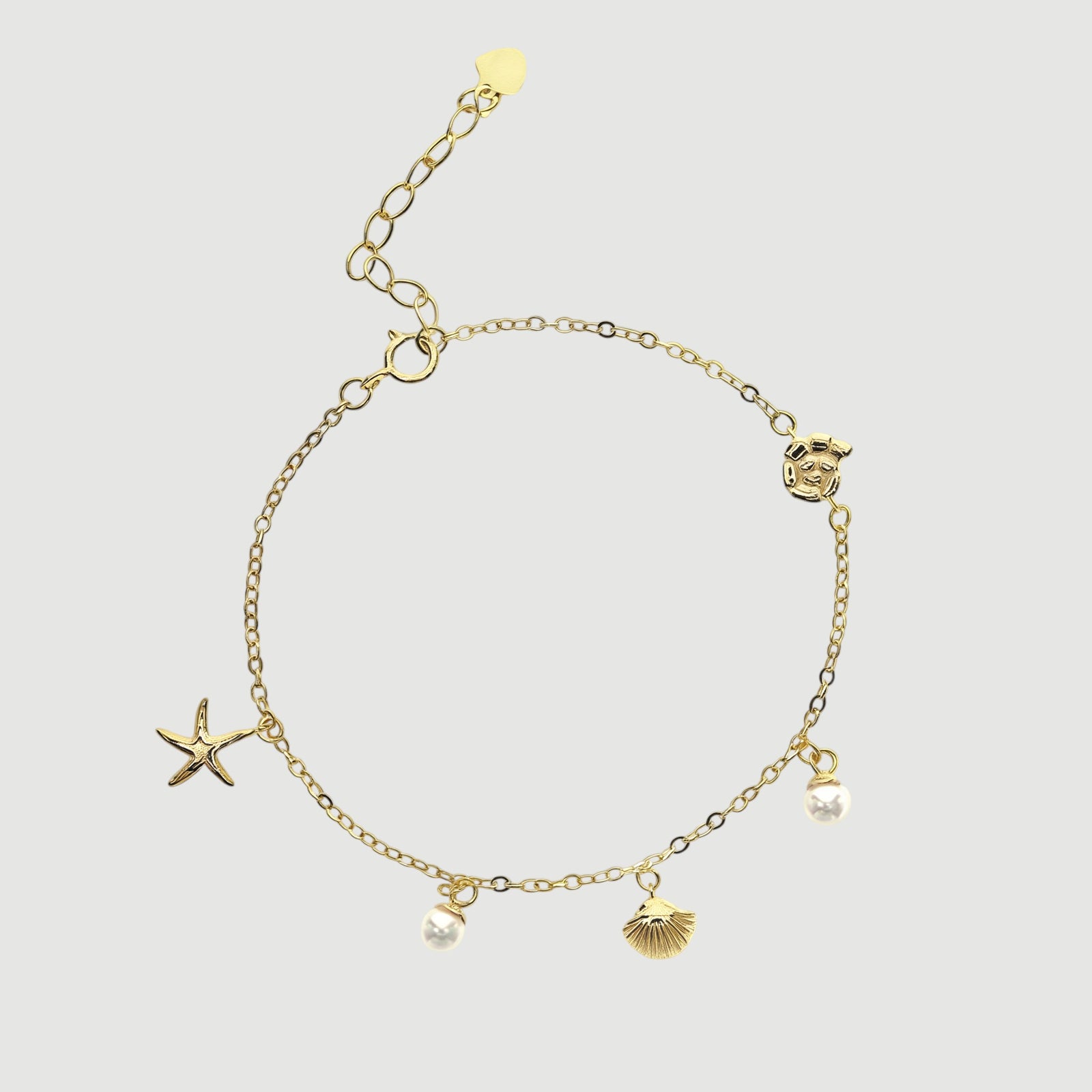 Amara Jewels gold-plated sterling silver bracelet with starfish, shell, pearl charms. Adjustable chain.