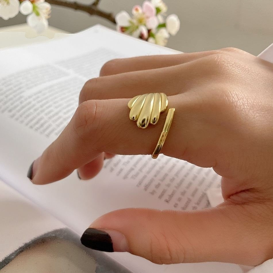 Amara Jewels gold shell open ring with wing design, polished finish, adjustable fit.