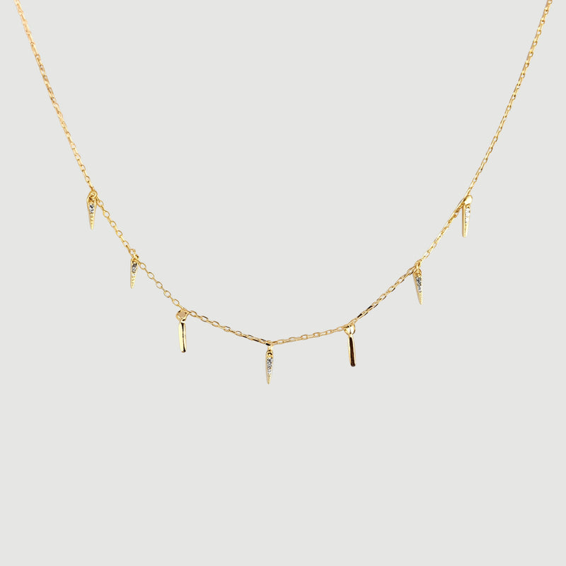 Amara Jewels gold-plated sterling silver necklace with dangling spike charms and small crystals.