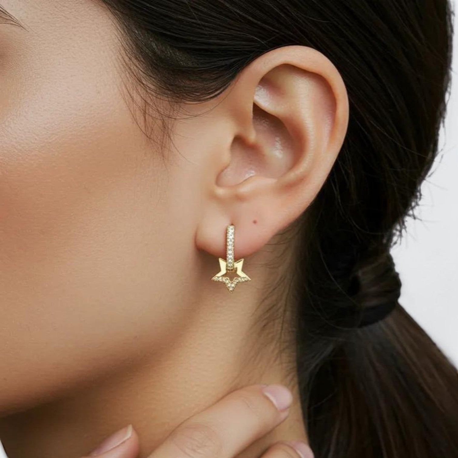 Amara Jewels gold-plated sterling silver hoop earrings with star motif adorned with cubic zirconia stones.
