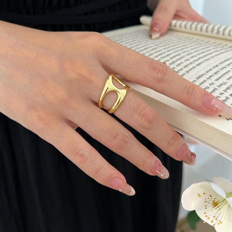 Amara Jewels gold open-cut statement ring with modern, abstract design. Made of 925 sterling silver with a gold finish.