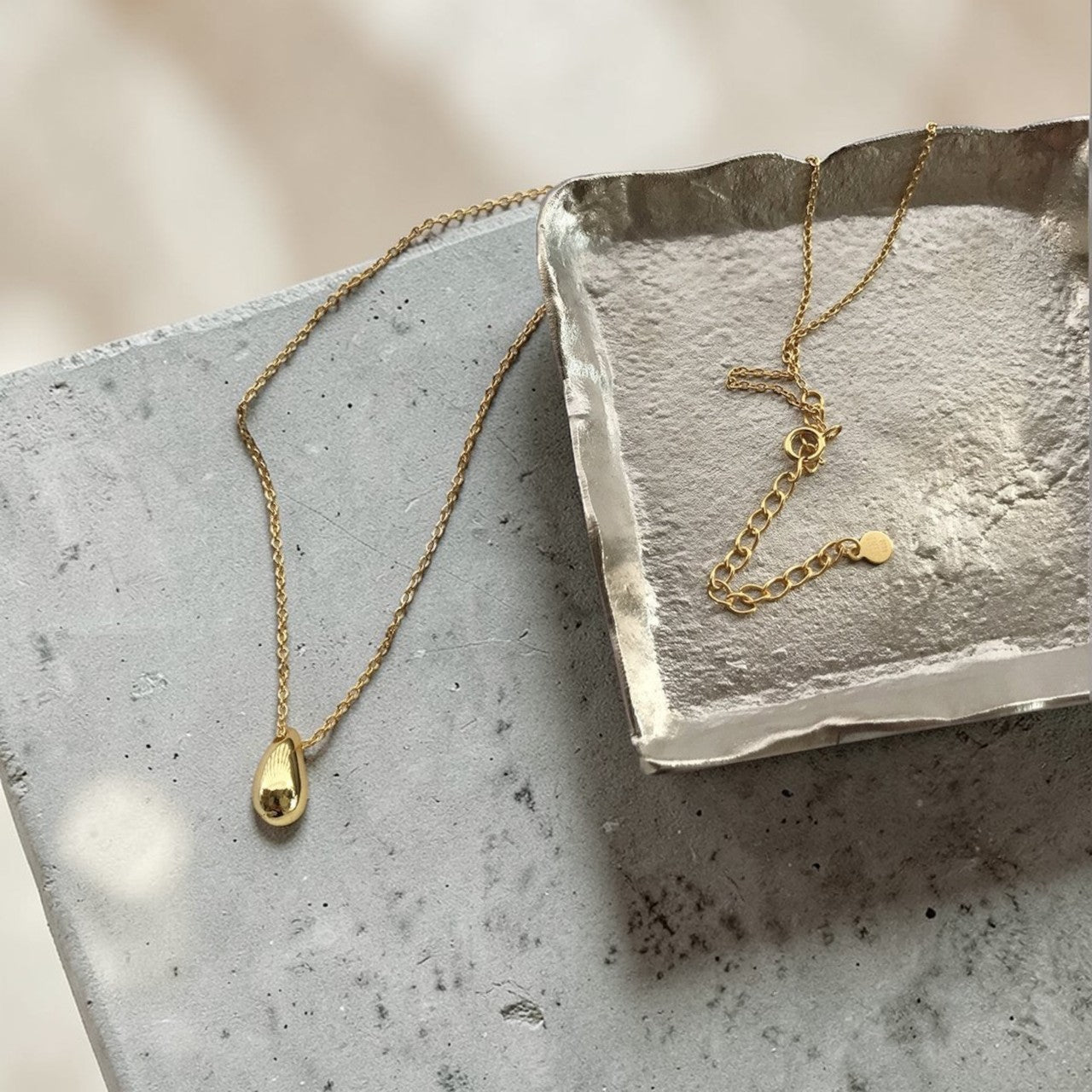 Amara Jewels gold tone teardrop pendant necklace on a dainty chain, made of 925 sterling silver.