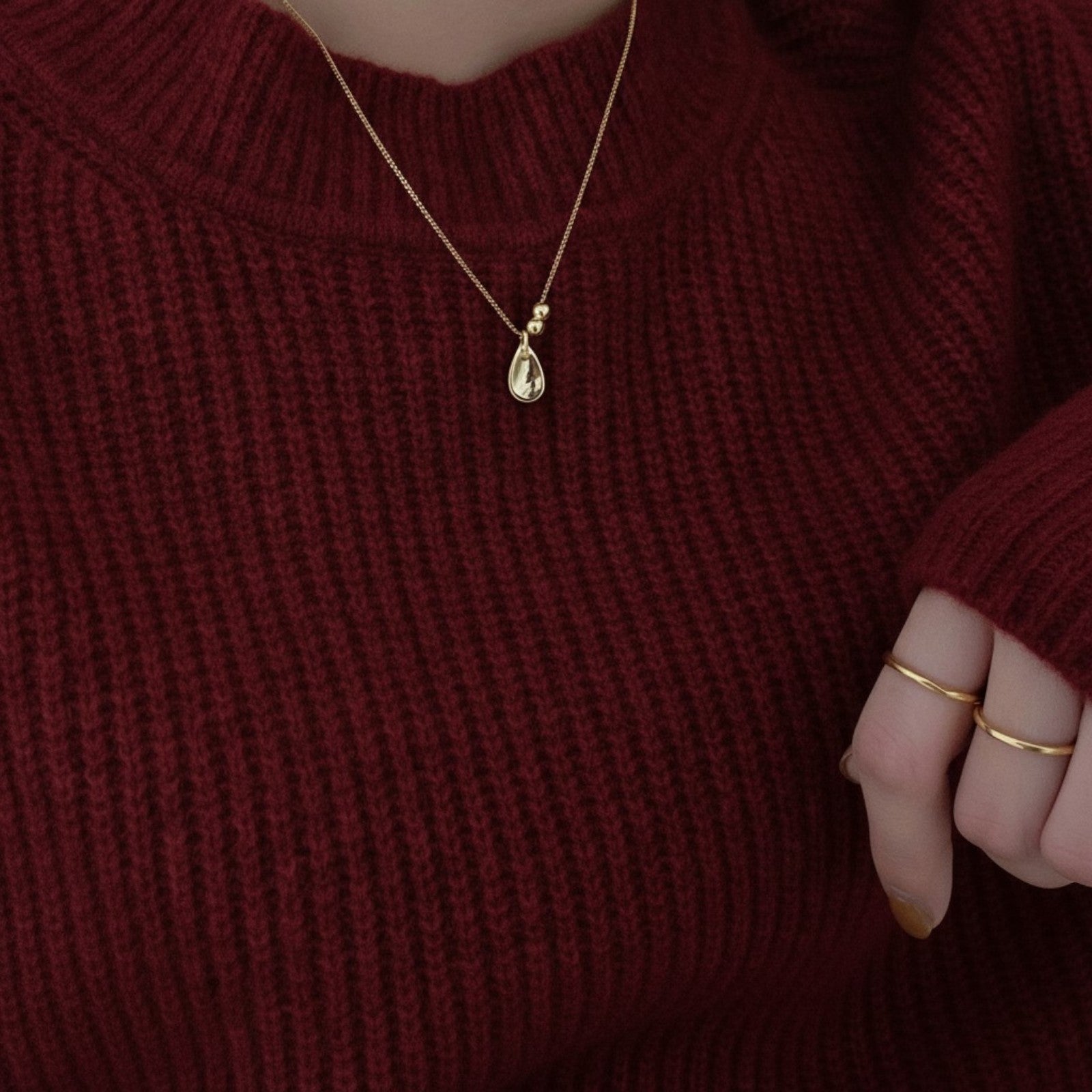 Amara Jewels 18K yellow gold polished sterling silver teardrop pendant necklace with two smooth beads on a delicate chain.