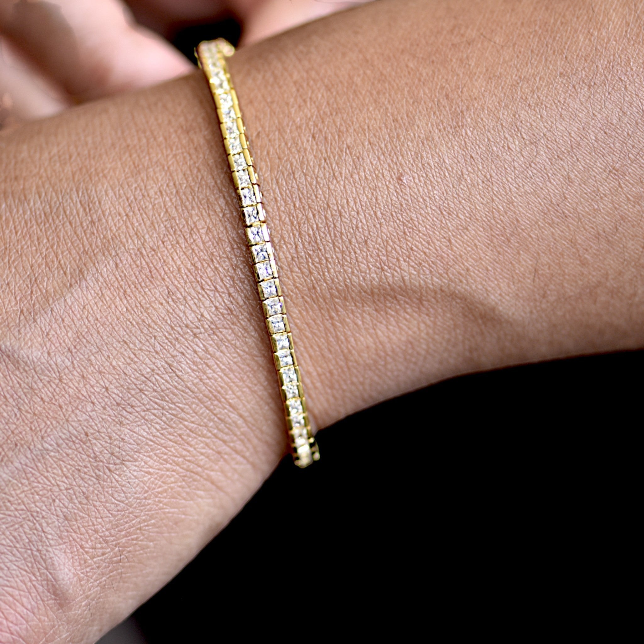Amara Jewels elegant gold tennis bracelet with sparkling square stones on sterling silver with gold finish.