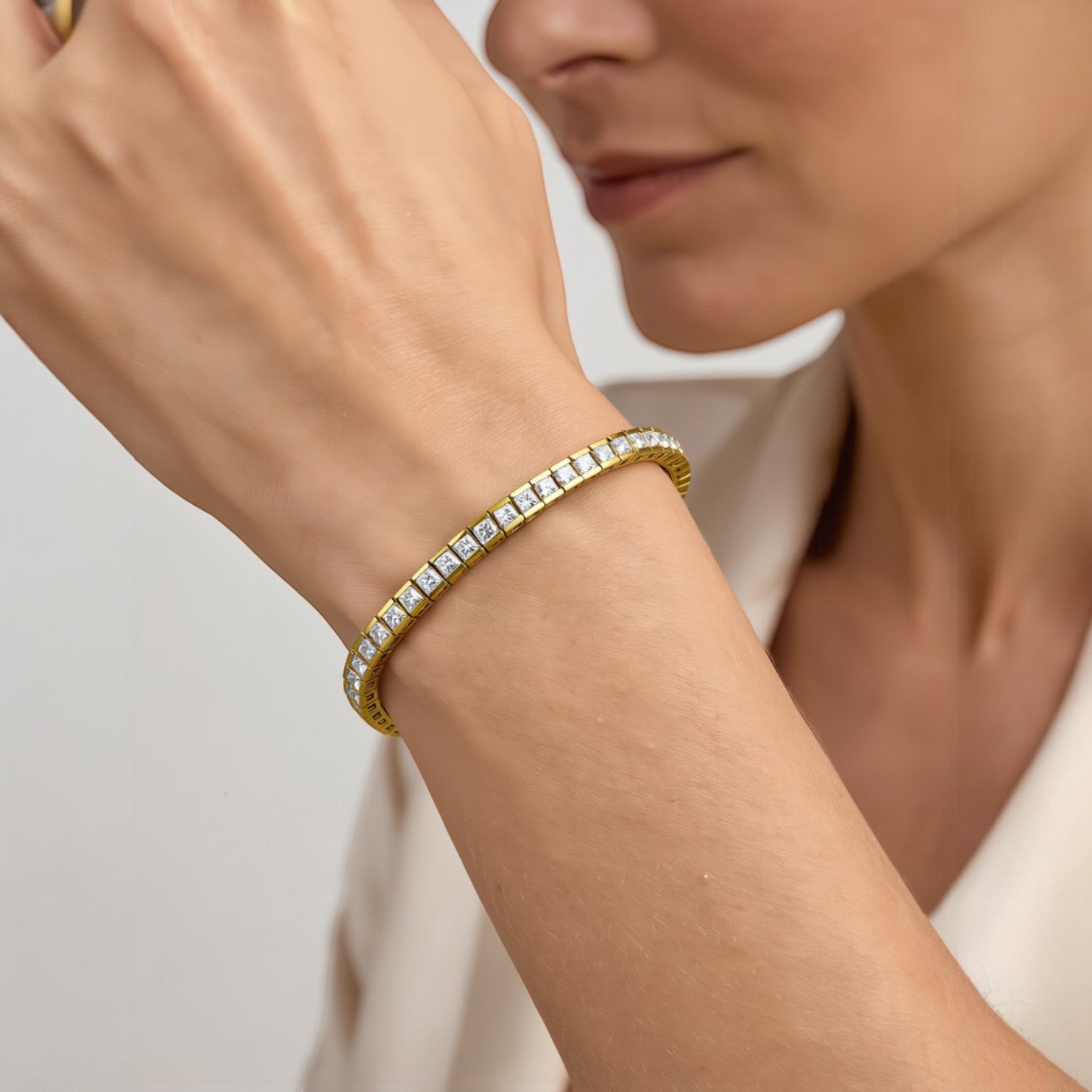 Amara Jewels elegant gold tennis bracelet with sparkling square stones on sterling silver with gold finish.