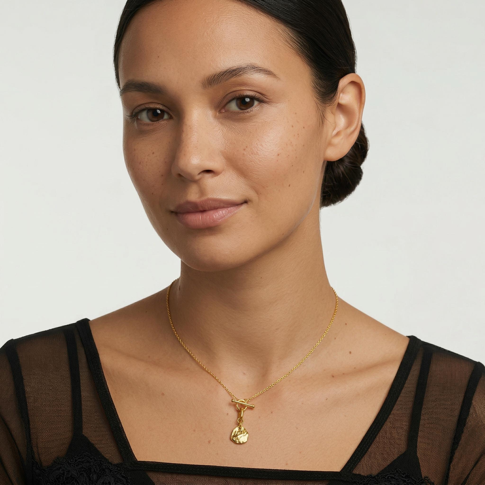 Amara Jewels gold-plated sterling silver necklace with toggle clasp and textured irregular charm.