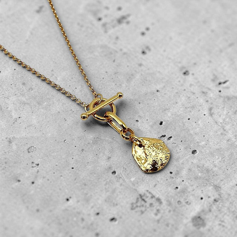 Amara Jewels gold-plated sterling silver necklace with toggle clasp and textured irregular charm.