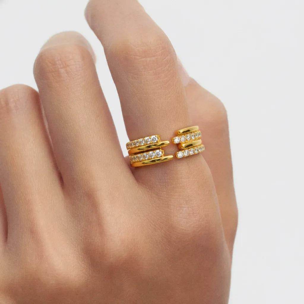 Amara Jewels gold-tone sterling silver open ring with three bands adorned with cubic zirconia.