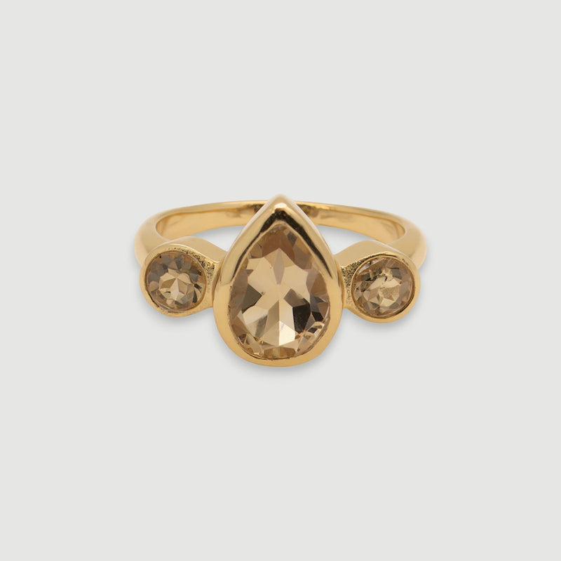 Amara Jewels elegant golden topaz ring with pear-shaped center stone and accent stones, 18K gold vermeil over 925 sterling silver.