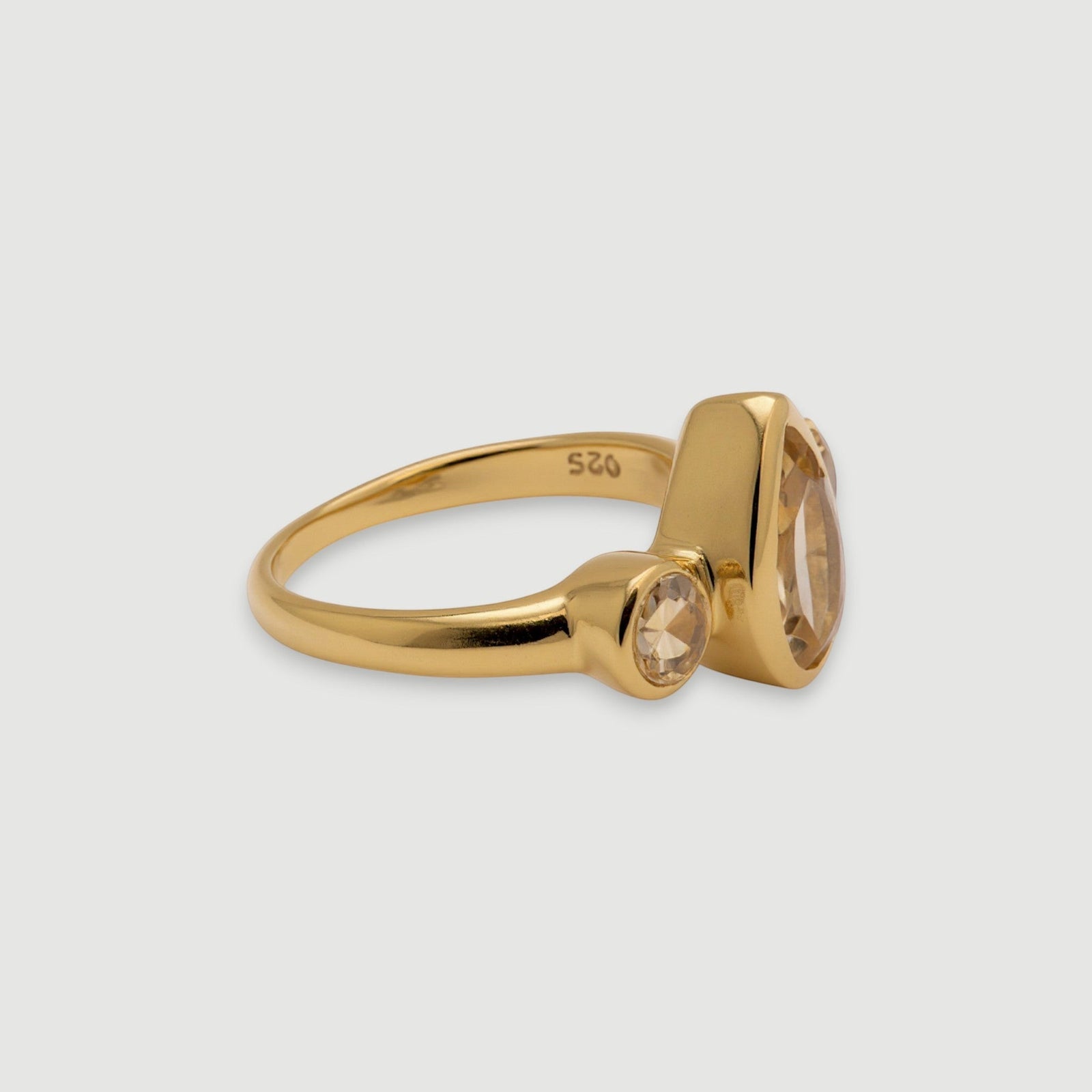 Amara Jewels elegant golden topaz ring with pear-shaped center stone and accent stones, 18K gold vermeil over 925 sterling silver.
