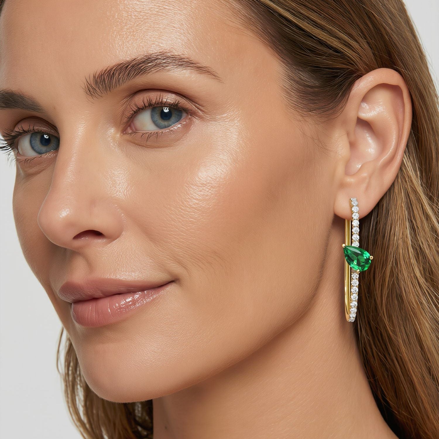 Amara Jewels gold-plated sterling silver hoop earrings with emerald green gemstones and clear CZ stones.