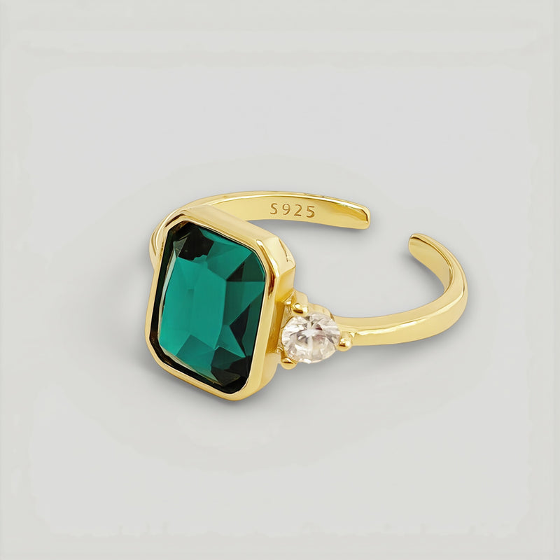 Amara Jewels gold-finish 925 sterling silver ring with rectangular emerald-green gemstone and cubic zirconia accent.