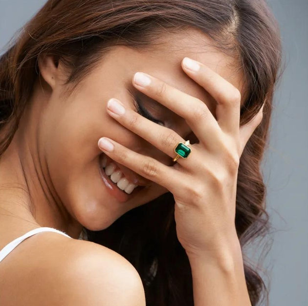 Amara Jewels gold-finish 925 sterling silver ring with rectangular emerald-green gemstone and cubic zirconia accent.