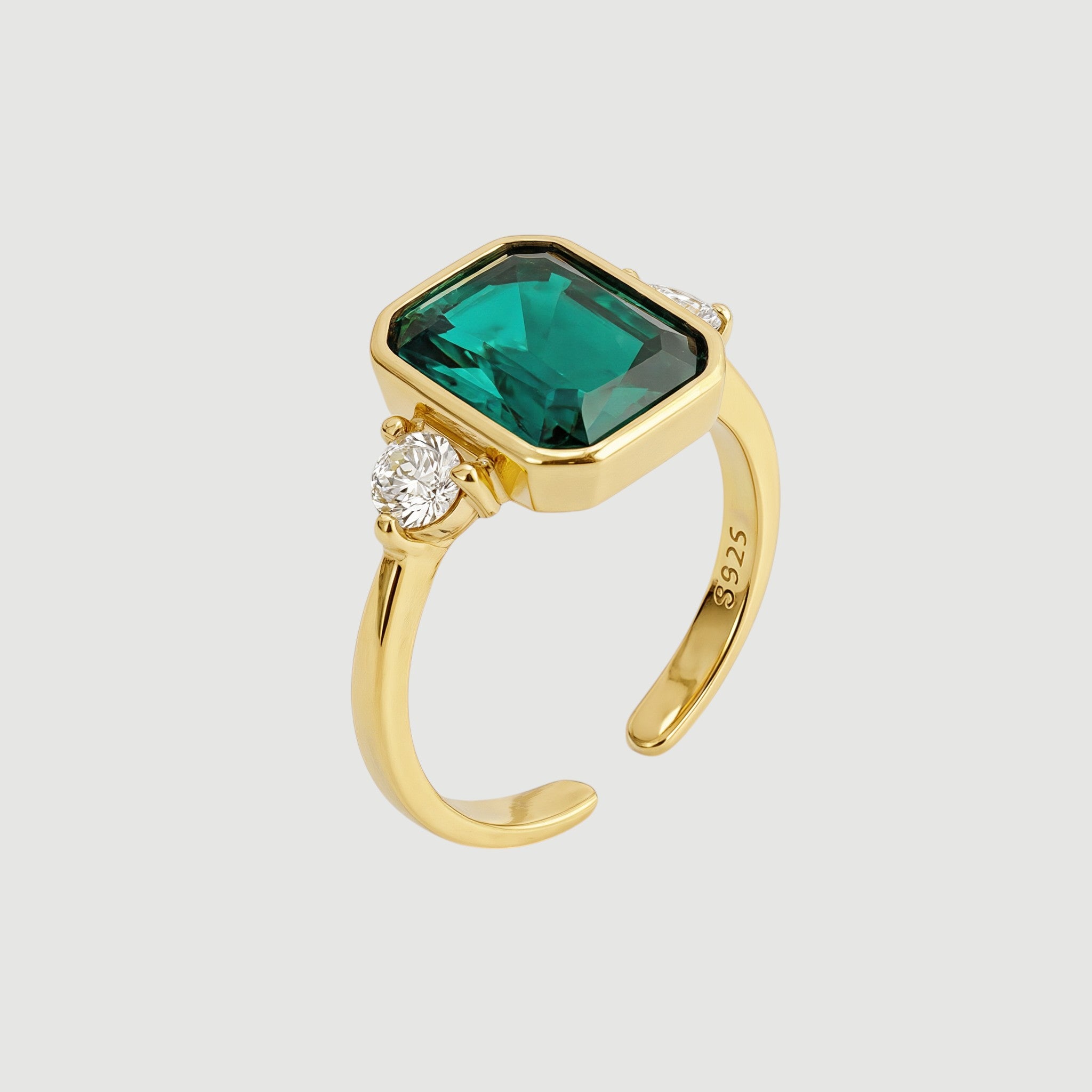 Amara Jewels gold-finish 925 sterling silver ring with rectangular emerald-green gemstone and cubic zirconia accent.