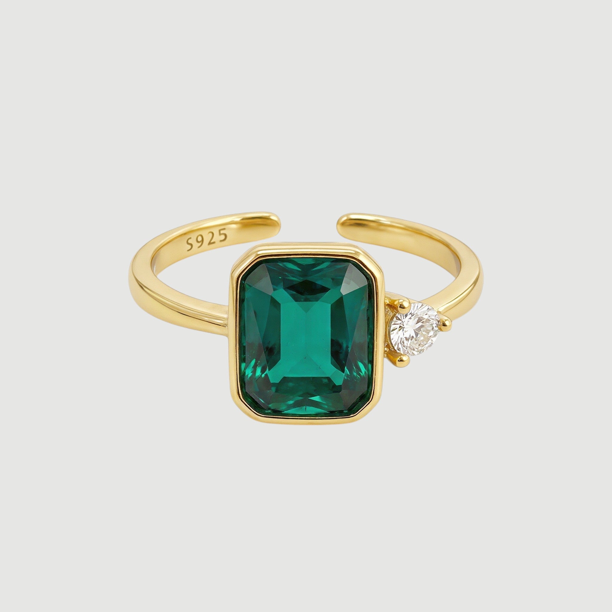 Amara Jewels gold-finish 925 sterling silver ring with rectangular emerald-green gemstone and cubic zirconia accent.