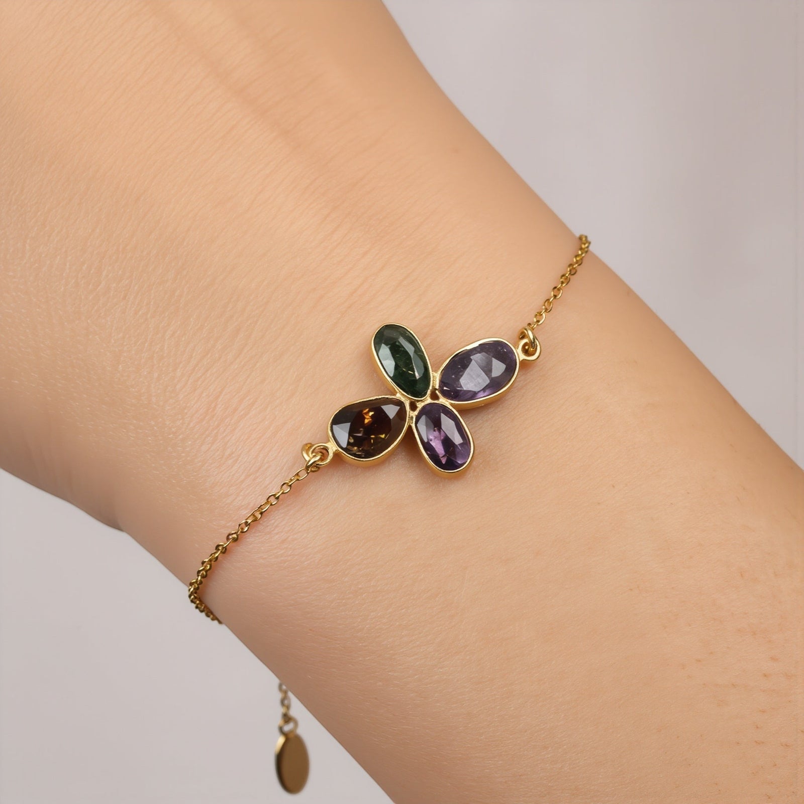 Amara Jewels Harmony Gemstone Bracelet in gold vermeil sterling silver with multi-colored natural gemstones arranged in a floral pattern.