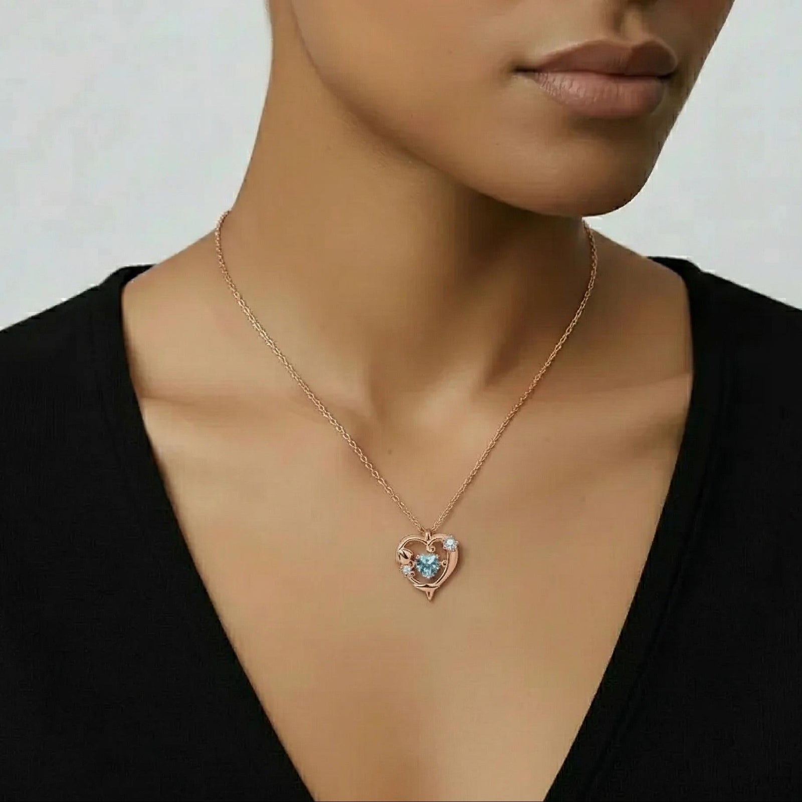 Amara Jewels rose gold plated sterling silver necklace with a heart-shaped aquamarine pendant and crystal accents.