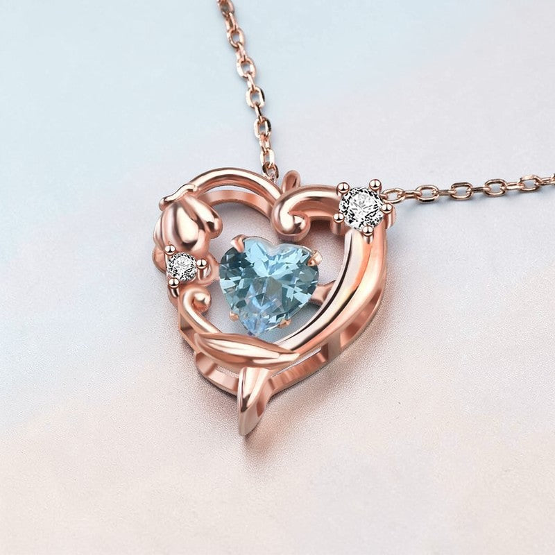 Amara Jewels rose gold plated sterling silver necklace with a heart-shaped aquamarine pendant and crystal accents.