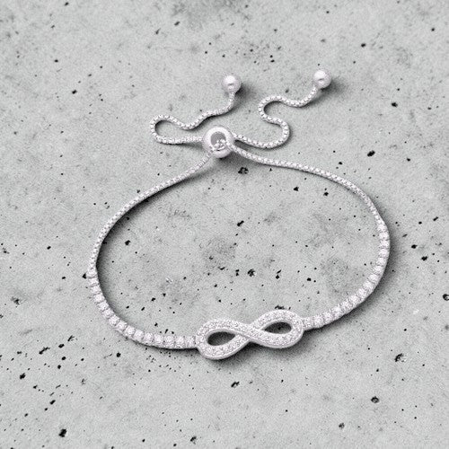 Amara Jewels sterling silver bracelet with infinity symbol and shimmering stones, adjustable slider clasp.