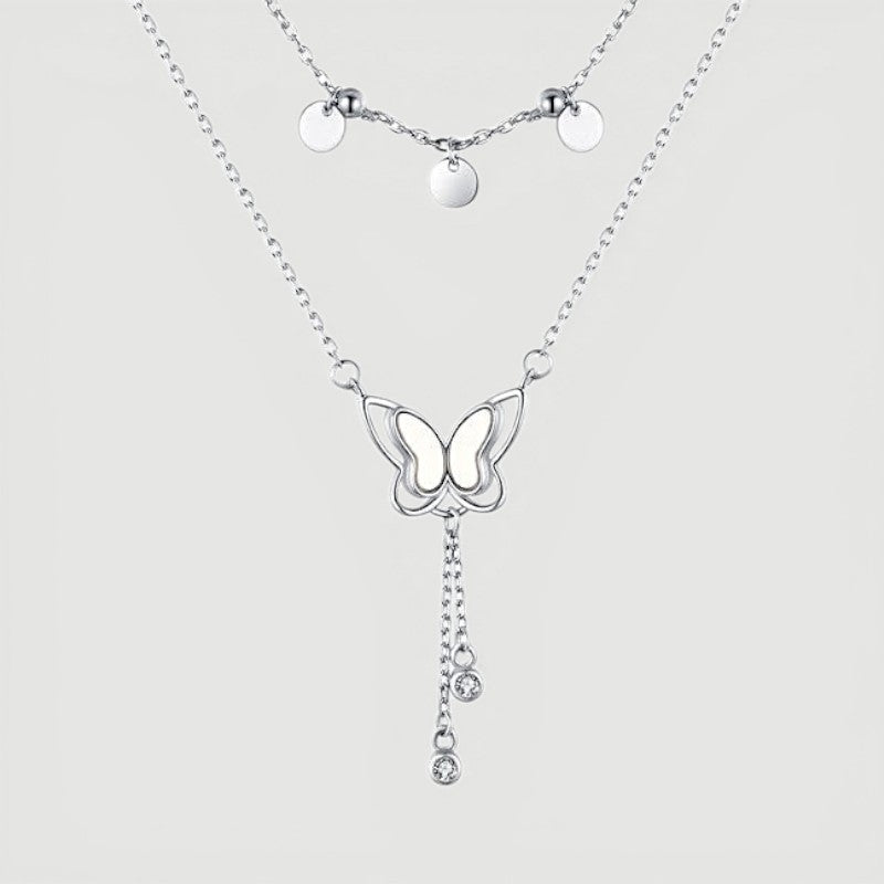 Amara Jewels double-layered sterling silver necklace with butterfly pendant and dangling crystals.