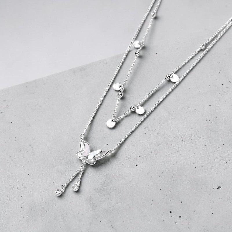Amara Jewels double-layered sterling silver necklace with butterfly pendant and dangling crystals.