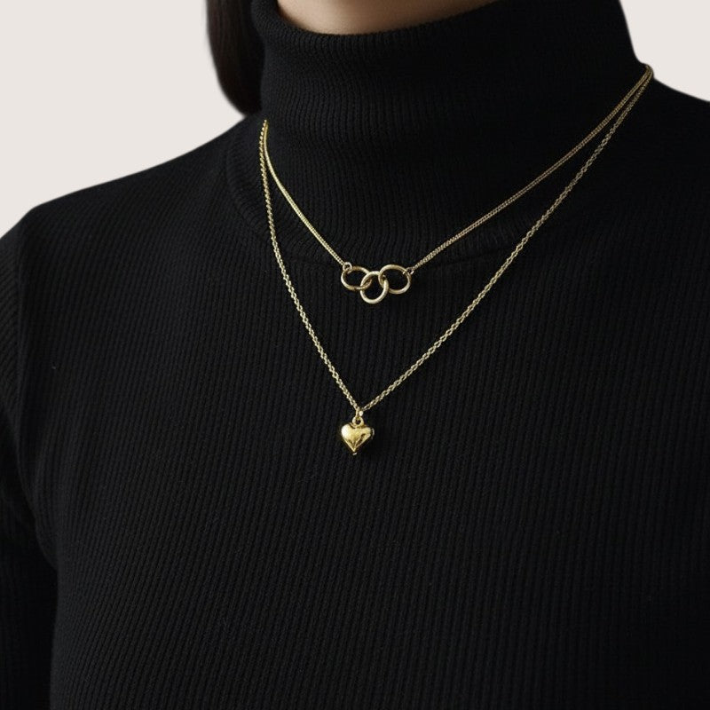 Amara Jewels gold-plated sterling silver layered necklace with heart and interlocking circles pendants.