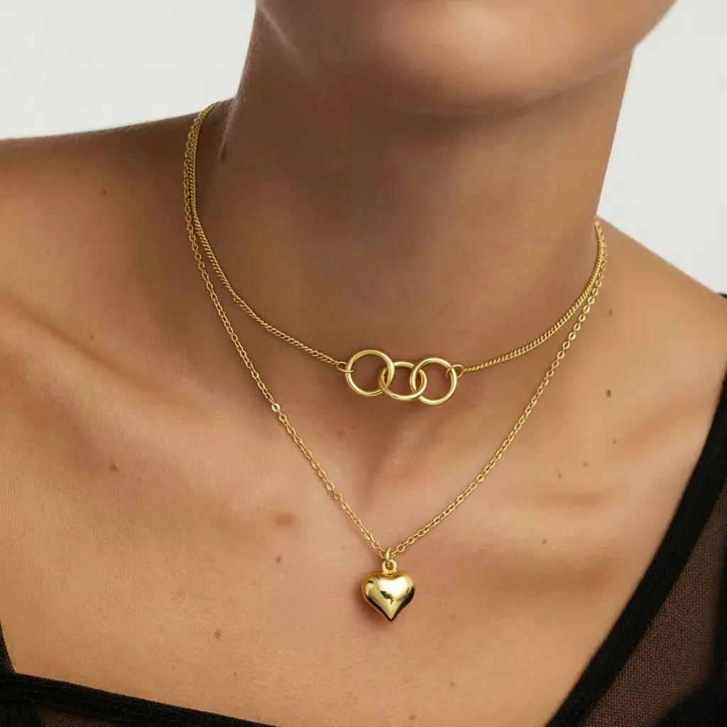 Amara Jewels gold-plated sterling silver layered necklace with heart and interlocking circles pendants.