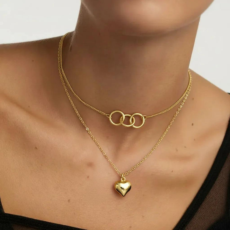 Amara Jewels gold-plated sterling silver layered necklace with heart and interlocking circles pendants.