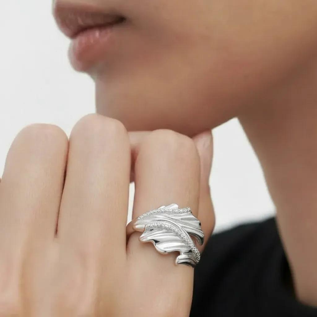 Amara Jewels sterling silver open ring with leaf design and sparkling accent stones.