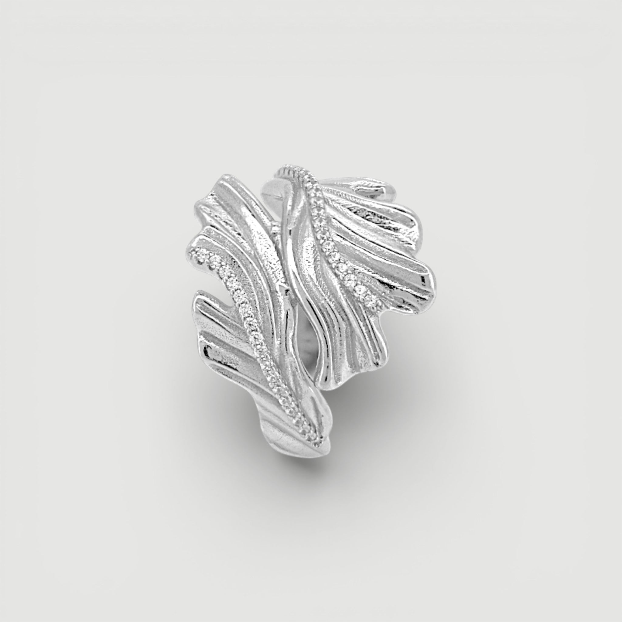 Amara Jewels sterling silver open ring with leaf design and sparkling accent stones.