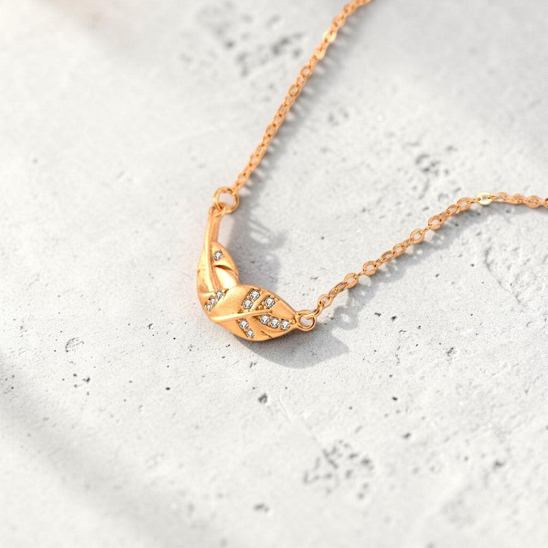 Amara Jewels gold-plated 925 sterling silver necklace with a leaf pendant adorned with cubic zirconia.
