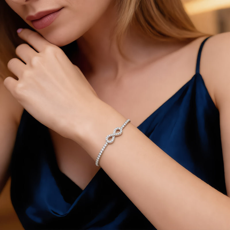 Amara Jewels sterling silver bracelet with infinity symbol adorned with stones, adjustable slider clasp.