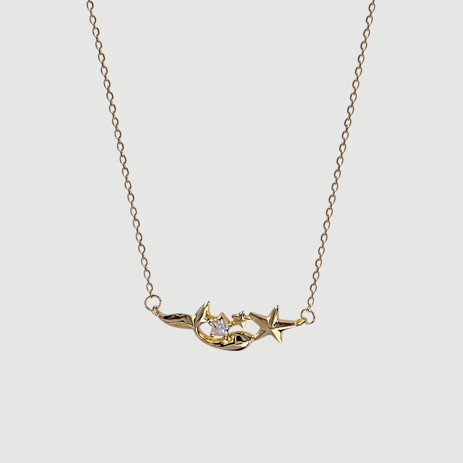Amara Jewels gold plated sterling silver mermaid and star necklace with crystal accent.