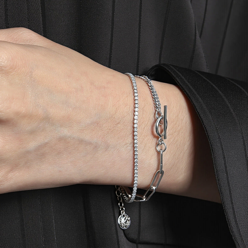 Amara Jewels layered chain sterling silver bracelet with toggle clasp featuring circle T charm.