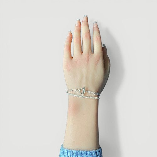 Amara Jewels layered chain sterling silver bracelet with toggle clasp featuring circle T charm.
