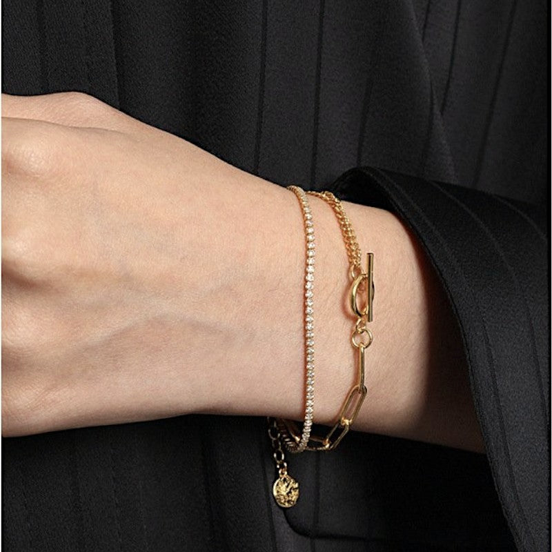Amara Jewels layered rhinestone gold chain bracelet with toggle clasp featuring circle T charm.