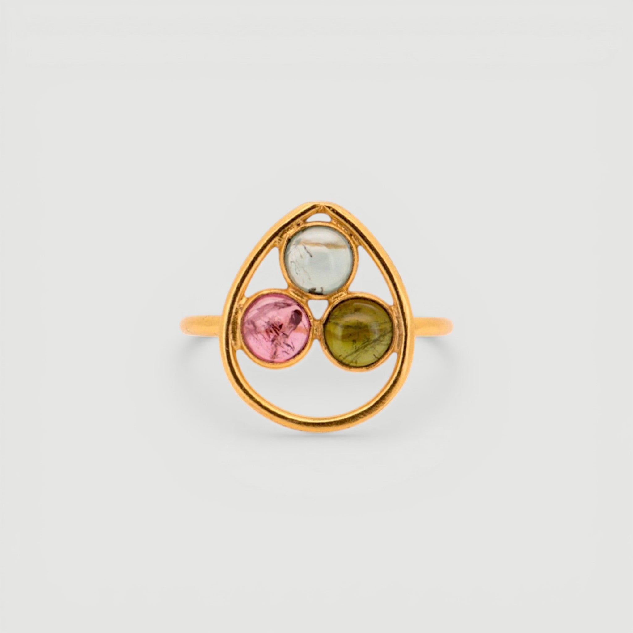 Amara Jewels gold vermeil ring with bezel-set pink, green, and black tourmaline gemstones in a sculptural open frame.