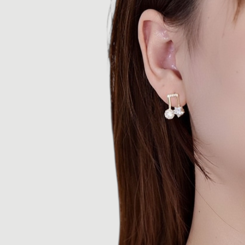 Amara Jewels gold-plated sterling silver asymmetrical music note and star earrings with cubic zirconia.