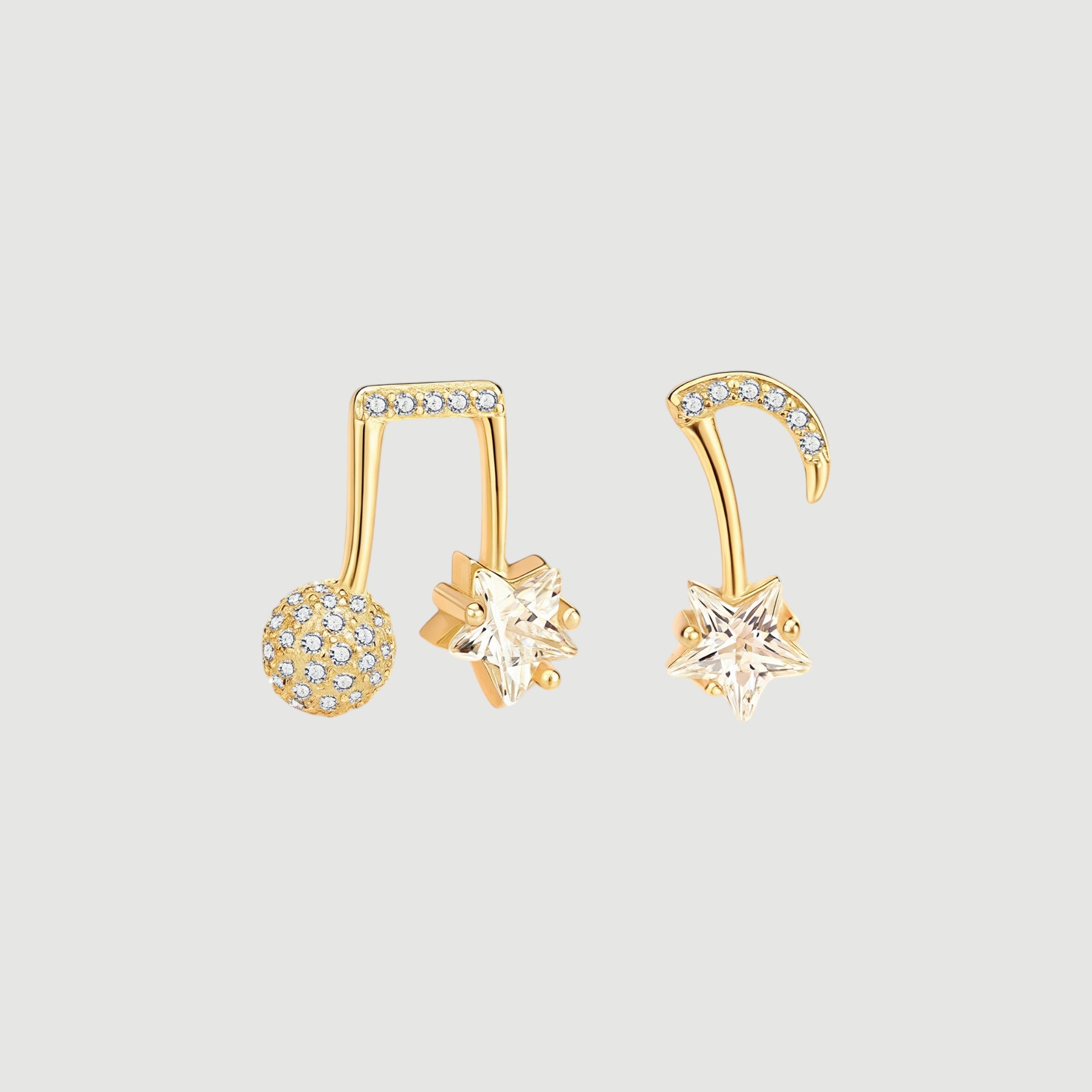 Amara Jewels gold-plated sterling silver asymmetrical music note and star earrings with cubic zirconia.