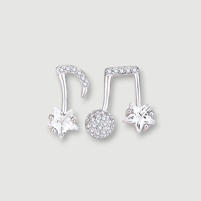 Amara Jewels gold-plated sterling silver asymmetrical music note and star earrings with cubic zirconia.
