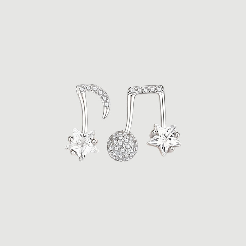 Amara Jewels gold-plated sterling silver asymmetrical music note and star earrings with cubic zirconia.