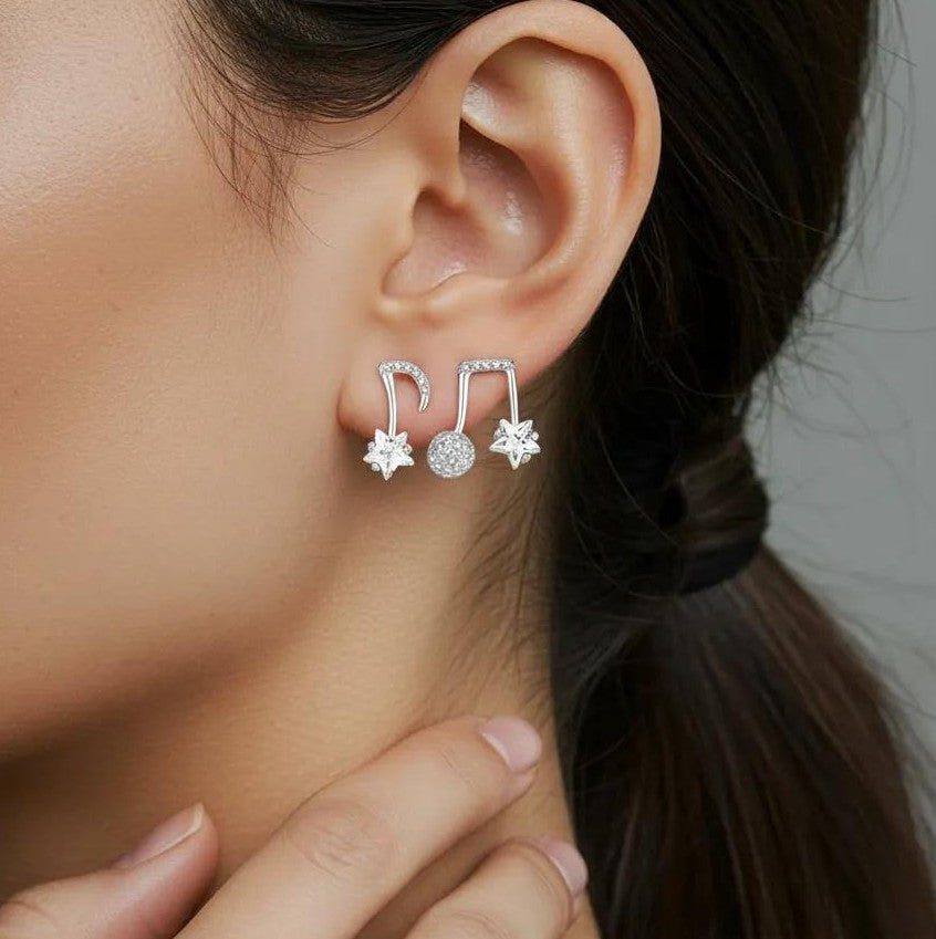 Amara Jewels gold-plated sterling silver asymmetrical music note and star earrings with cubic zirconia.