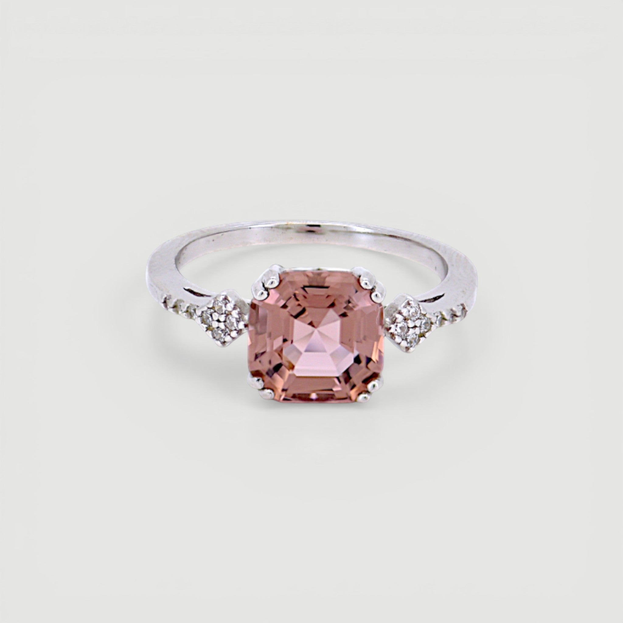 Amara Jewels 925 sterling silver ring with a square-cut pink sapphire and small zirconia accents on the band.
