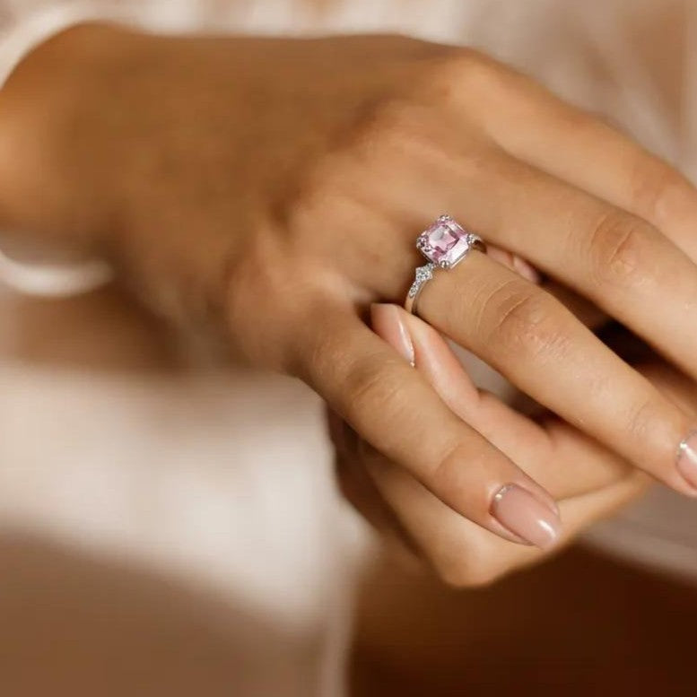 Amara Jewels 925 sterling silver ring with a square-cut pink sapphire and small zirconia accents on the band.