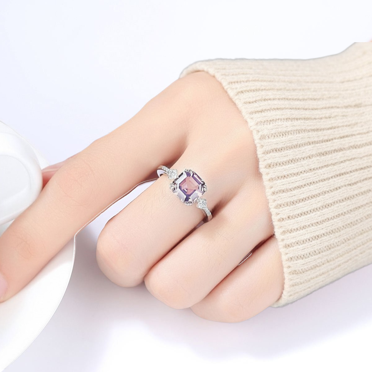 Amara Jewels 925 sterling silver ring with a square-cut pink sapphire and small zirconia accents on the band.