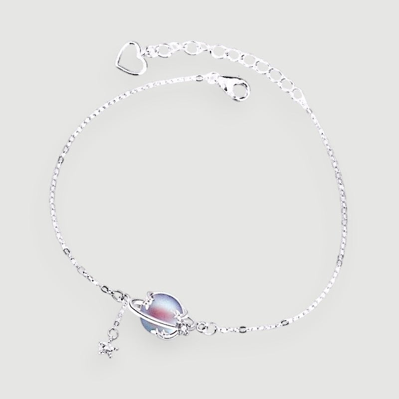 Amara Jewels 925 sterling silver adjustable bracelet with iridescent blue planet charm and dangling star.