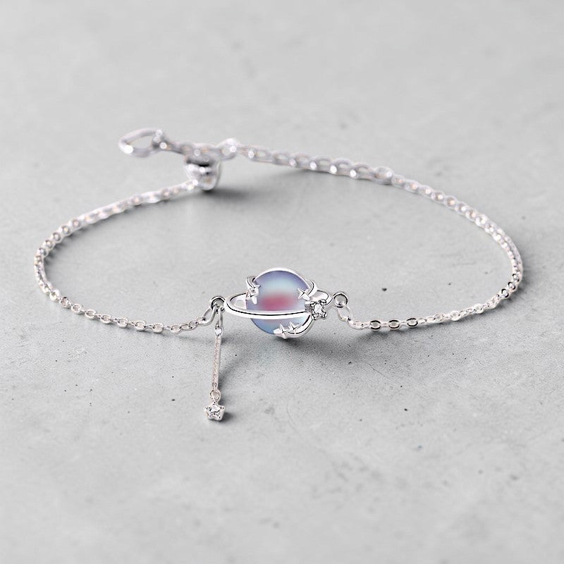 Amara Jewels 925 sterling silver adjustable bracelet with iridescent blue planet charm and dangling star.