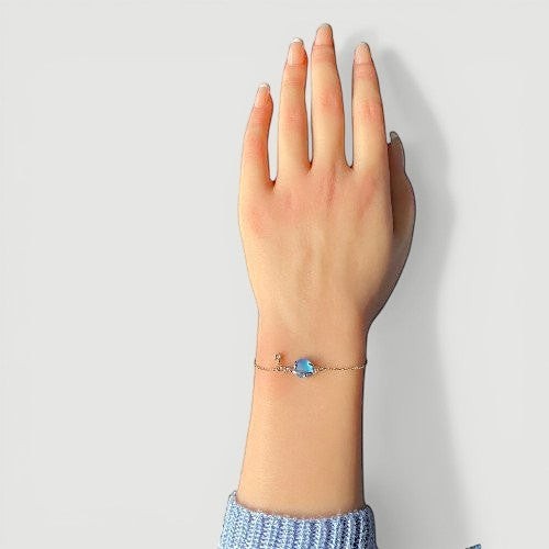 Amara Jewels 925 sterling silver adjustable bracelet with iridescent blue planet charm and dangling star.